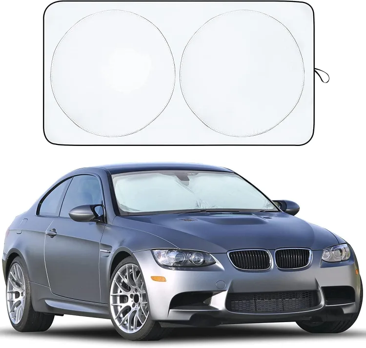 The silver two-circle EcoNour windshield shade above a grey coupe with the shade in its windshield