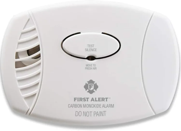 The First Alert CO400 carbon monoxide detector, a round white battery unit